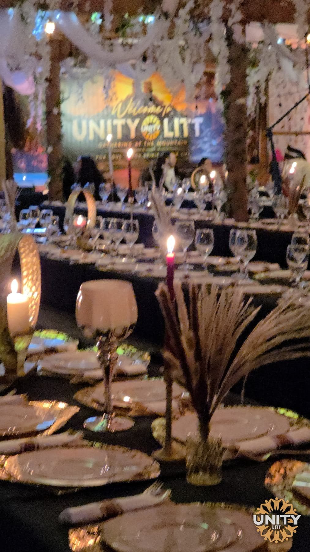 The dining room laid out before a meal, the UnityLitt name lit on the wall